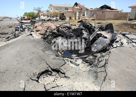 Remains of a US Marine Corps AV-8B Harrier fighter aircraft that crashed in a housing development June 5, 2014 in Imperial, California. Eight homes were evacuated with three destroyed but no injuries reported. Stock Photo