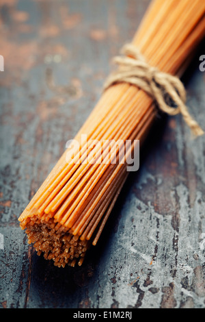 whole wheat spaghetti on wooden background Stock Photo
