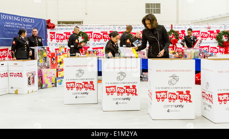 First lady Michelle Obama, second from right, helps sort donated toys during a U.S. Marine Corps Reserve Toys for Tots campaign Stock Photo