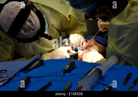 From left, U.S. Air Force Maj. Melissa Fisher, an oral and maxillofacial surgeon with the 633rd Medical Group, and Senior Airma Stock Photo