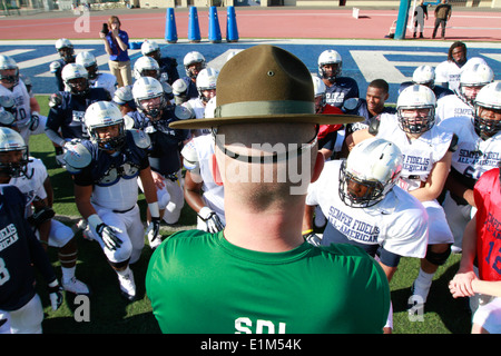 U.S. Marine Corps Sgt. Brian Craddock, a drill instructor assigned to Marine Corps Recruit Depot, San Diego, speaks with player Stock Photo