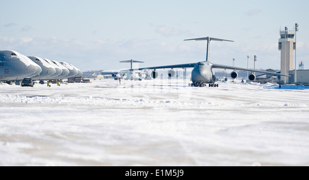 U.S. Airmen tow a C-5M Super Galaxy aircraft at Dover Air Force Base, Del., Jan. 3, 2014. Airmen with the 436th Civil Engineer Stock Photo