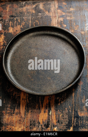 old frying pan on wooden board Stock Photo