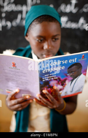 African schoolboy. AIDS prevention book Stock Photo