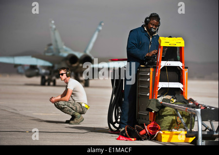 U.S. Air Force Staff Sgt. Tyrin Rush, right, a crew chief with the 366th Aircraft Maintenance Squadron, looks at a technical or Stock Photo