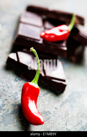 Dark chocolate with chili pepper over wooden background Stock Photo