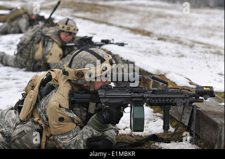 A U.S. Soldier assigned to the 1st Squadron, 91st Cavalry Regiment, 173rd Infantry Brigade Combat Team (Airborne) fires an M249 Stock Photo