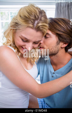 Cute affectionate couple relaxing on bed together Stock Photo