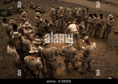 U.S. Marines with Alpha Company, 1st Battalion, 4th Marine Regiment, 13th Marine Expeditionary Unit (MEU) are briefed before a Stock Photo