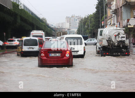 Istanbul. 6th June, 2014. Cars move on a flooded road in Adana in Turkey, on June 6, 2014. Excessive precipitation, which started from the beginning of the week paralyzed daily life in several parts of the country. Heavy downpours triggered flash floods in some rural and mountain areas of Turkey. Main roads were waterlogged due to floods since the beginning of the week. According to meteorology reports, the rainfall will continue till next week. Credit:  Cihan/Xinhua/Alamy Live News Stock Photo