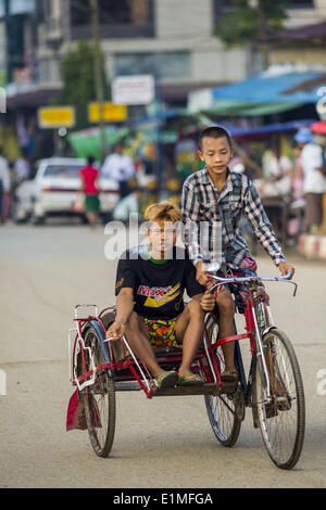 June 6, 2014 - Pantanaw, Ayeyarwady Region, Myanmar - Boys on a pedicab in Pantanaw, a town in the Irrawaddy Delta (or Ayeyarwady Delta) in Myanmar. The region is Myanmar's largest rice producer, so its infrastructure of road transportation has been greatly developed during the 1990s and 2000s. Two thirds of the total arable land is under rice cultivation with a yield of about 2,000-2,500 kg per hectare. FIshing and aquaculture are also important economically. Because of the number of rivers and canals that crisscross the Delta, steamship service is widely available. (Credit Image: © Jack Kurt Stock Photo