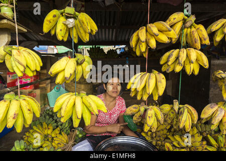 June 6, 2014 - Pantanaw, Ayeyarwady Region, Myanmar - A woman sells bananas in the market in Pantanaw, a town in the Irrawaddy Delta (or Ayeyarwady Delta) in Myanmar. The region is Myanmar's largest rice producer, so its infrastructure of road transportation has been greatly developed during the 1990s and 2000s. Two thirds of the total arable land is under rice cultivation with a yield of about 2,000-2,500 kg per hectare. FIshing and aquaculture are also important economically. Because of the number of rivers and canals that crisscross the Delta, steamship service is widely available. (Credit  Stock Photo