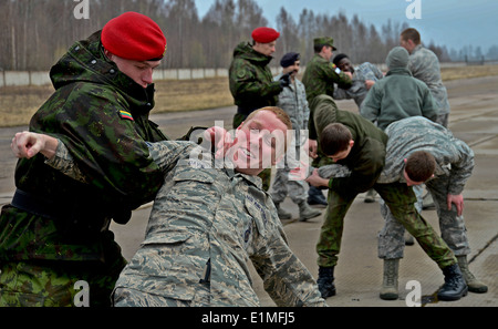 U.S. Airmen assigned to the 48th Air Expeditionary Group and Lithuanian air force military police members practice mechanical a Stock Photo