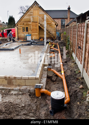 self building house, drainage pipes being connected to gullies around site Stock Photo