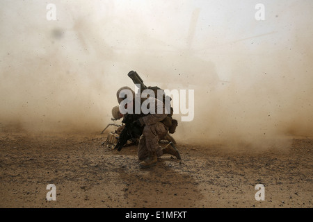 U.S. Marine Corps Cpl. Daniel Hopping, an assaultman with Weapons Company, 1st Battalion, 7th Marine Regiment, shields himself Stock Photo