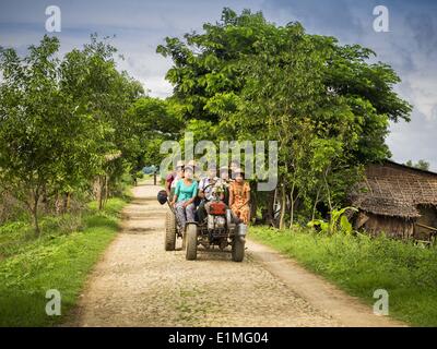 June 6, 2014 - Pantanaw, Ayeyarwady Region, Myanmar - A local ''bus'' in the Irrawaddy Delta (or Ayeyarwady Delta) in Myanmar. The region is Myanmar's largest rice producer, so its infrastructure of road transportation has been greatly developed during the 1990s and 2000s. Two thirds of the total arable land is under rice cultivation with a yield of about 2,000-2,500 kg per hectare. FIshing and aquaculture are also important economically. Because of the number of rivers and canals that crisscross the Delta, steamship service is widely available. (Credit Image: © Jack Kurtz/ZUMAPRESS.com) Stock Photo