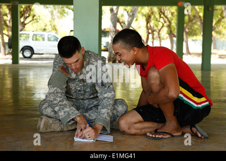 U.S. Army Sgt. John-Kyle Truitt, left, with the 486th Civil Affairs Battalion, teaches English to a Dominican soldier May 4, 20 Stock Photo