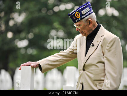 Leslie Cruise, a World War II veteran, pays respect to the grave of his friend Pvt. Richard Vargas at Lorraine American National Cemetery and Memorial June 5, 2014 in St. Avold, France. Seventy years ago on June 7, 1944 Pvt. Richard Vargas saved Cruise’s life during the invasion of Normandy. Stock Photo