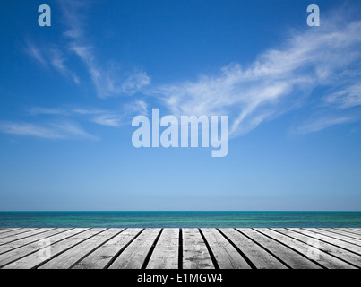 Empty gray wooden pier with sea and cloudy sky on background Stock Photo