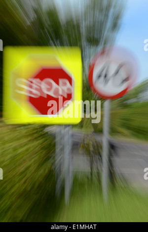 zoom exposure of roadside stop sign and 40 mph warning sign at road junction Yorkshire UK Stock Photo
