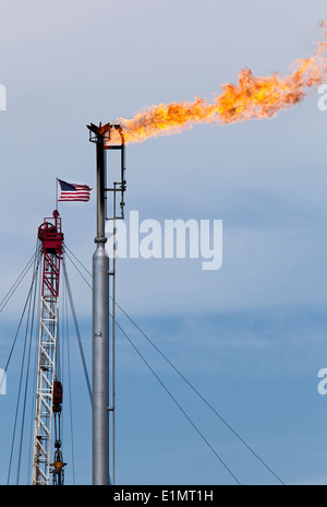 Epping, North Dakota - Natural gas is flared off as oil is pumped in the Bakken shale formation. The Stock Photo