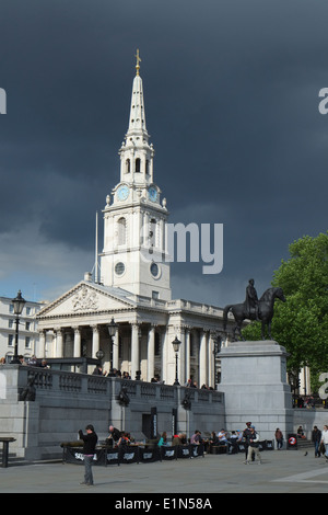 Storm clouds gather over St Martins church in London's Trafalgar Square Stock Photo