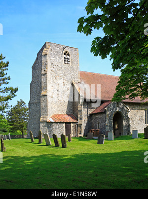 A view of the tower and south porch of the parish church of St John the Baptist at Trimingham, Norfolk, England, United Kingdom. Stock Photo