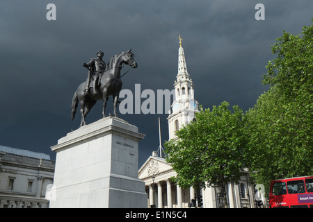 King George iV statue in Trafalgar Square with Red London Bus and Storm Clouds gathering with St Martins Church in the backgroun Stock Photo