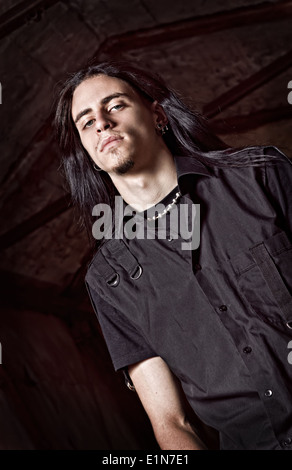 Portrait of a handsome young man with long hair. Low key Stock Photo