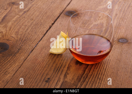 Luxury Cognac in decorative glass on wood with lemon Stock Photo