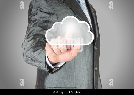 Businessman pushes virtual cloud button. Cloud computing concept Stock Photo