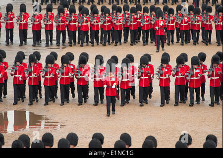 Horse Guards, London UK. 7th June 2014. The final rehearsal of the Queen’s Birthday Parade, the Colonel’s Review, begins in heavy rain with large puddles forming on the parade ground. Nijmegen Company Grenadier Guards troop the Colour. Credit:  Malcolm Park editorial/Alamy Live News Stock Photo