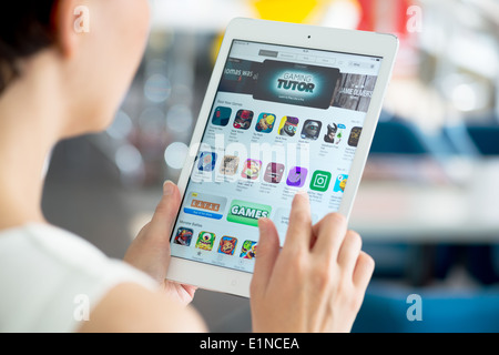 Woman looking for a new game apps using App Store on brand new Apple iPad Air Stock Photo
