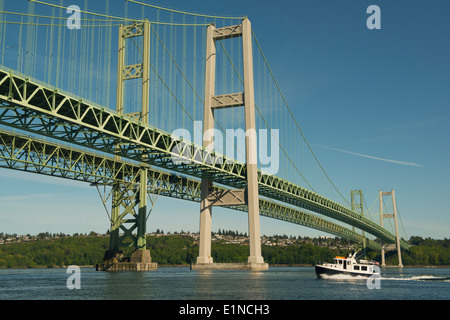 Boat passes under Tacoma Narrows Bridge, Puget Sound, Tacoma, Washington Stock Photo