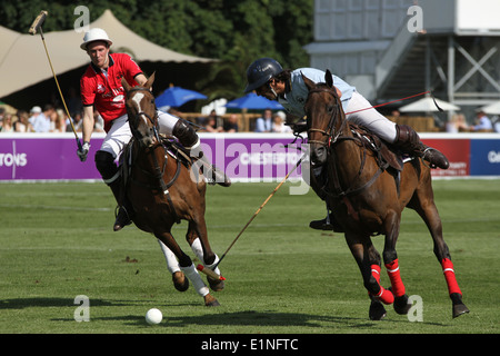 Oscar Mancini of Team Buenos Aires v Charlie Wooldridge of Team Beijing at Chestertons polo in the park 2014 Stock Photo