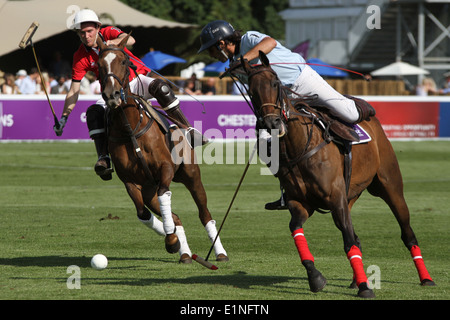 Oscar Mancini of Team Buenos Aires v Charlie Wooldridge of Team Beijing at Chestertons polo in the park 2014 Stock Photo