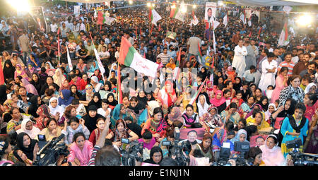 Karachi. 7th June, 2014. Supporters of the Muttahida Qaumi Movement (MQM) Party gather in a street to celebrate the on-bail releasing of the MQM leader Altaf Hussain in southern Pakistani port city of Karachi on June 7, 2014. The exiled leader of Pakistan's MQM party was released on bail by British police in London on Saturday. Altaf Hussain was arrested at his London home last Tuesday for interrogation, which had since then prompted thousands of people to protest on streets of Karachi. © Masroor/Xinhua/Alamy Live News Stock Photo