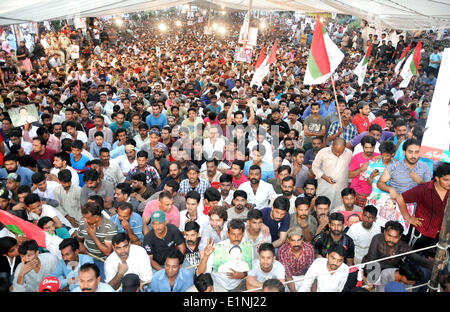Karachi. 7th June, 2014. Supporters of the Muttahida Qaumi Movement (MQM) Party gather in a street to celebrate the on-bail releasing of the MQM leader Altaf Hussain in southern Pakistani port city of Karachi on June 7, 2014. The exiled leader of Pakistan's MQM party was released on bail by British police in London on Saturday. Altaf Hussain was arrested at his London home last Tuesday for interrogation, which had since then prompted thousands of people to protest on streets of Karachi. © Masroor/Xinhua/Alamy Live News Stock Photo