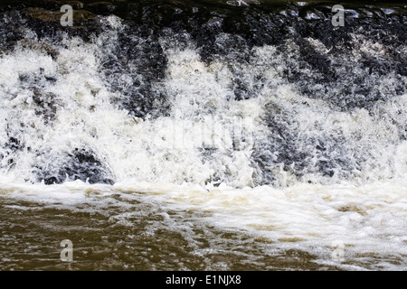 River tumbling over a weir. Stock Photo