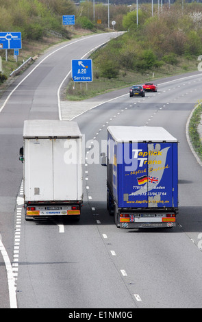 Rear view of two trucks traveling along the M20 motorway in Kent, England Stock Photo