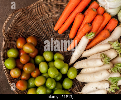 Fresh organic vegetables in wicker baskets at asian market Stock Photo