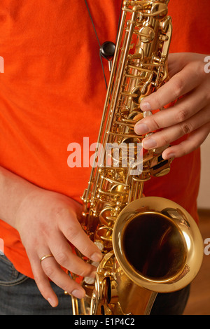 Playing the saxophone at home Stock Photo