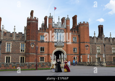 The exterior of Hampton Court Palace in the London Borough of Richmond upon Thames, UK – with Henry VIII and two wives. Stock Photo