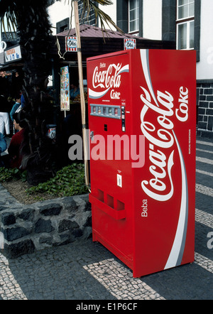 A bright red Coca-Cola vending machine stands outdoors in Ponta Delgada on Sao Miguel Island in the Azores, an archipelago in the North Atlantic Ocean. Stock Photo