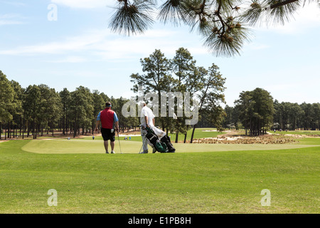 Golfer and Caddie, PInehurst Resort Golf Course, Pinehurst, North Carolina, USA Stock Photo