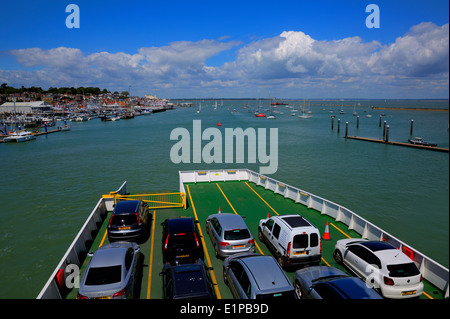 Car ferry leaving port with cars in rows blue sea and sky East Cowes isle of Wight Stock Photo