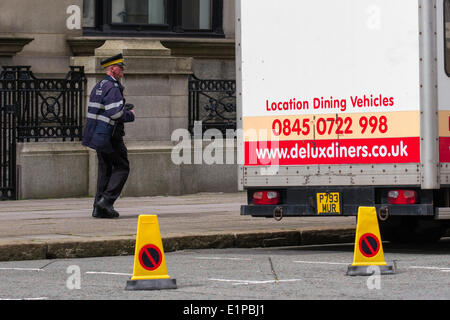 Liverpool, Merseyside, UK 8th June, 2014. Parking Warden approaching Location Dining Vehicles as filming for BBC1 drama continues - based on the story of Chester Zoo to be told in a new BBC1 family drama set to air next year. The scripts are written by Matt Charman and it will be directed by Andy de Emmony who worked on The Bletchley Circle . The drama, being filmed on location in Liverpool and Walton Hall Park in Warrington by production company Big Talk, will cover the zoo’s early years. Credit:  Mar Photographics/Alamy Live News Stock Photo