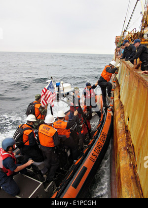 US Coast Guard Cutter Morgenthau crew and members of the China Fisheries Law Enforcement Command board the fishing vessel Yin Yuan detained for illegal fishing using drift nets in the North Pacific Ocean June 3, 2014. Stock Photo