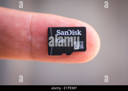 Close-up of Micro SD Card on finger Stock Photo