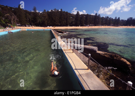 Woman swimming in rockpool at Palm Beach, northern beaches of Sydney, NSW, Australia. No MR Stock Photo